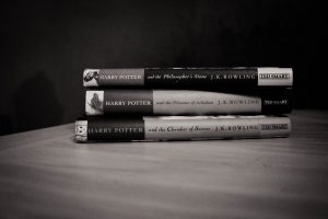 A black and white photo of a stack of Harry Potter books